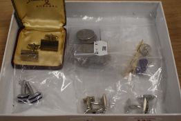 A variety of cufflinks, also included are a few American coins.