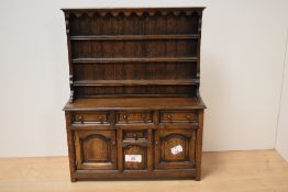 A vintage oak dolls Welsh dresser, with functioning drawers and doors.