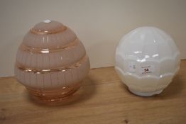 Two vintage lamp shades, including moulded opaque shade and pink frosted shade.