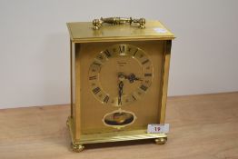 A brass 'Timemaster' mantel clock in German case.