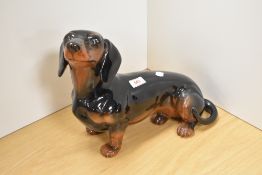 A Beswick Pottery fireside 'Dachshund' 2286 in black and tan gloss, designed by Albert Hallam