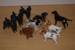 A group of nine Beswick pottery dog figures, comprising three black gloss poodles 1386, a matt black