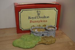 A Royal Doulton Bunnykins 'Robin Hood Collection' castle form display stand, with original