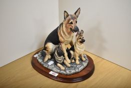 A Border Fine Arts animal group 'German Shepherd & Pups' B0351, designed by Margaret Turner, resting