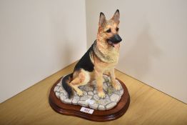 A Border Fine Arts animal group 'German Shepherd' MT06, designed by Margaret Turner, resting on a