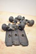 A tub of vintage turned wood door knobs and finger plates