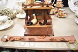 A vintage pipe wrack and four pipes, including Orlik Lieutenant, Special R and De Pat Old Bruyere.