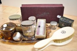 A selection of vintage dressing table items, including tortoiseshell effect mirror, tray and trinket