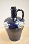 An Art Noveau bottle vase, having dark blue ground with thistle decoration, marked to underside