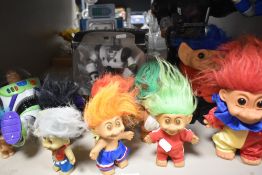 A collection of trolls, boxed Robosapien toy, Buzz lightyear etc.