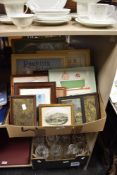 A box of varied prints, etched brass wall plaques, framed Vintage style adverts and more.