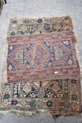 Two traditionally styled Turkish fringed rugs, with repeating motif design.