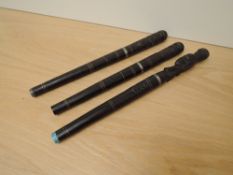 An African wood with metal bladed Tribal Dagger with circular stick scabbard, grip carved in a