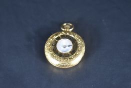 An 18k yellow metal top-wound half-hunter fob watch, of traditional circular form with engraved