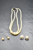 A double row of graduated pearls with silver clasp, a pair of cultured pearl stud earrings and a