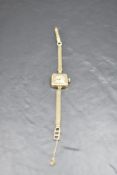 A lady's vintage 18ct gold wrist watch by Scilla having Arabic numeral dial to square face in