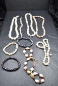 A black jewellery case containing a selection of baroque pearl necklaces