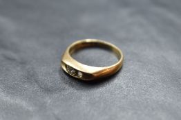 A 9ct rose gold ring having a central diamond, approx 0.05ct in an open boat form mount on 9ct