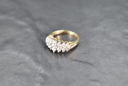 A 14 stone double row diamond ring, total approx 1ct in a claw set stepped mount on a 14ct gold