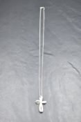 A diamond set 18ct white gold cross pendant of 3D looped form on a 9ct white gold chain, approx
