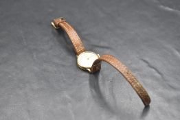 A lady's 9ct gold wrist watch by Tissot having Arabic numeral dial to champagne face in plain case