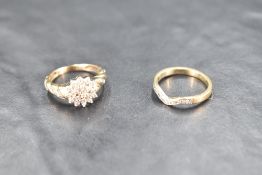 A diamond triple cluster ring with diamond set moulded shoulders, total approx 0.25ct on a 9ct