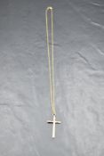 A 9ct gold cross pendant having cut decoration on a yellow metal chain stamped 9K, approx 18' & 1.