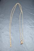 A rose gold muff chain bearing plaque marked 9ct, approx 54' & 18.7g