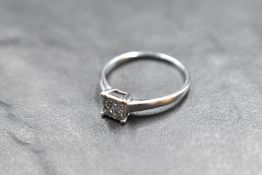 A four stone princess cut diamond ring, total approx 0.37ct in a four claw collared basket mount