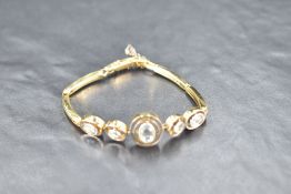 A white and yellow metal bracelet stamped 18,having spring bar links, box clasp and articulated