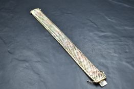A 9ct tri coloured plaited brick effect cuff bracelet having concealed clasp, approx 200mm & 35g
