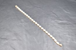 A 14ct gold articulated bracelet having twenty two claw set opals with an oval box clasp, approx