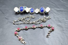 A white metal articulated bracelet stamped 800 having six lapis lazuli cabochon panels