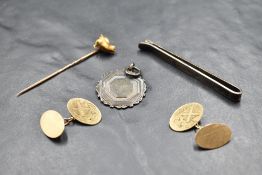 A pair of 9ct gold cufflinks of oval form having engraved shield with motto: MEDIOC RIA FIRMA,