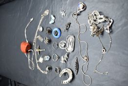 A small jewellery box containing a selection of silver and white metal jewellery including enamelled