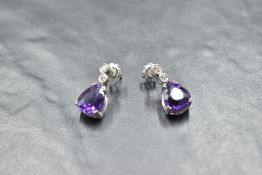A pair of 18ct white gold stud earrings ears having collared diamond studs with further diamond