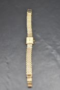 A lady's 9ct gold wrist watch by Rotary having baton numeral dial to rectangular face on a fixed