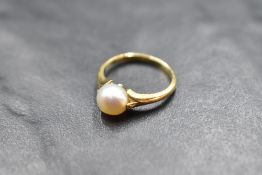 A cultured pearl solitaire ring having split shoulders and an 18ct gold loop, size G & approx 2.2g