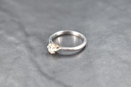 A diamond solitaire ring, approx 0.5ct in a claw set collared mount on a white metal loop stamped