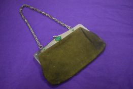 An early 20th century handbag, in moss green leather with green gem stones to stainless steel