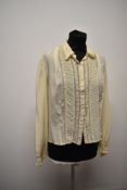 A 1940s cream long sleeved blouse.