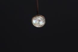 A Rene Lalique 'Man in the moon' hat pin, having iridescent glass insert, set in white metal.