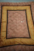 A vintage 1930s eiderdown, in black and terracotta colourway.