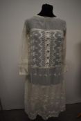 A 1920s embroidered smock or over dress, having extensive detail throughout.