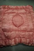 A vintage 1930s pink satin eiderdown.