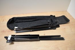A folding metal music stand with case