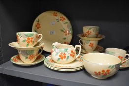 A Crown Devon hand painted part tea service on yellow ground