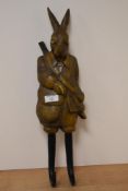 A modern coat hook in the form of a hare garbed in shooting attire.