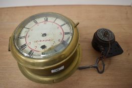 An antique brass ships Bolkhead clock, having bevelled glass door and roman numerals to face,'SS