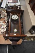 An early 20th Century mahogany Vienna style wall clock, the enamelled dial with two train